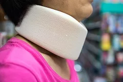 Close-Up Side View Of Woman Wearing Neck Collar