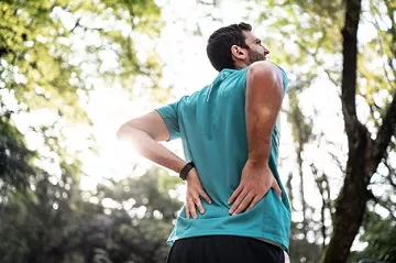 Male runner with back pain stemming from Ankylosing Spondylitis